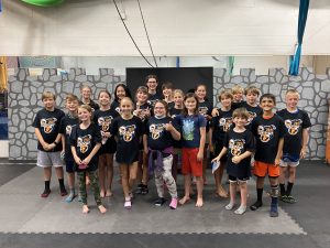 Stunt campers smile in a group photo at the end of a week of camp